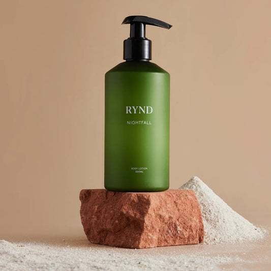 Green bottle with black pump labeled 'RYND' on a beige background