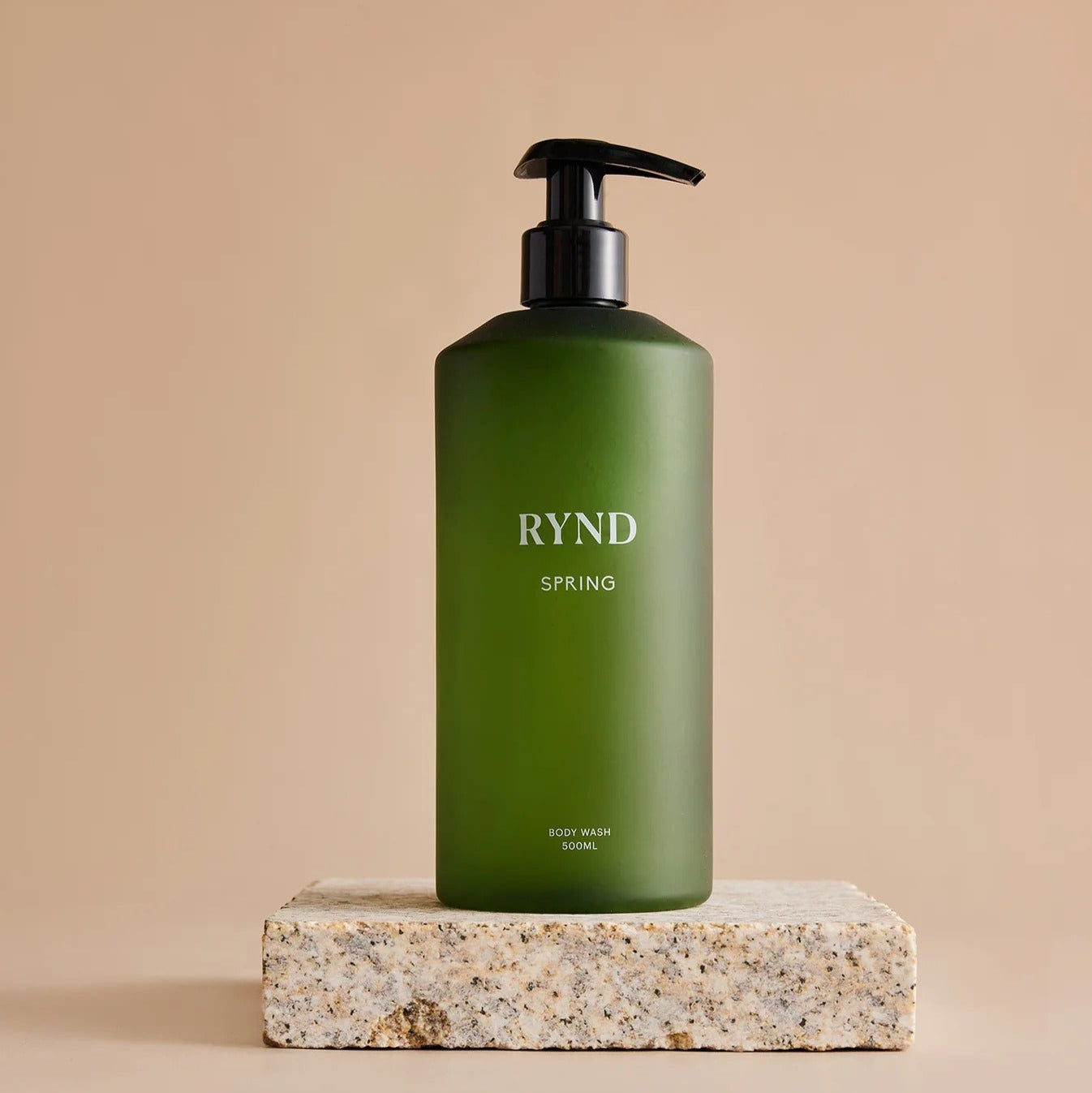 Green bottle labeled 'RYND' on a beige background